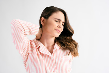 Young woman suffering from neck pain