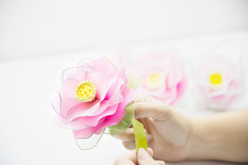 Obraz na płótnie Canvas Woman making beautiful nylon flower - people with DIY handmade flower concept