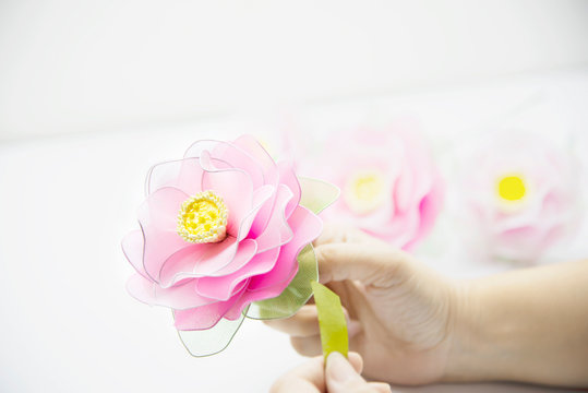 Woman making beautiful nylon flower - people with DIY handmade flower concept