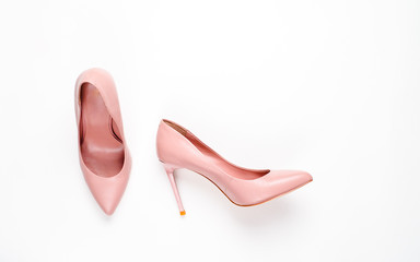 Pale pink female shoes on white background. Flat lay, top view trendy fashion feminine background. Beauty blog concept.