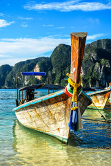 Boat standing in Loh Dalam Bay, blue sky with few clouds, Ko Phi Phi, Thailand