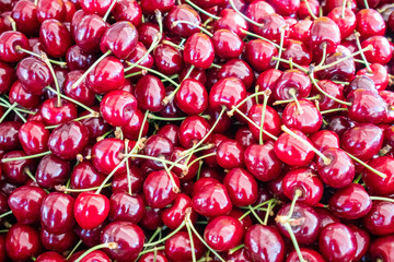 Cherries pile at farmers market, background, texture
