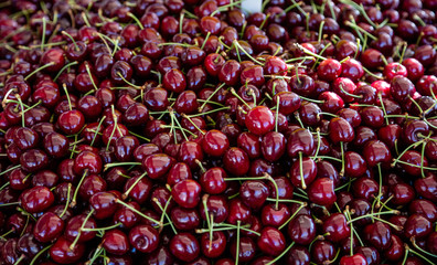 Cherries pile at farmers market, background, texture