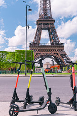 Scooter on the street of Paris. Car rental. Youth trends and fashion technology. The Eiffel Tower.