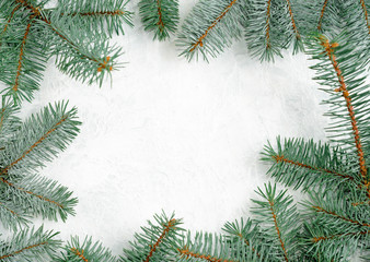 Christmas frame made of branches of a New Year tree. Christmas wallpaper. Flat lay, top view, copy space