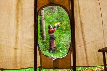 Fusion of cultural & modern music event. A spiritual man is viewed through an opening in a native...