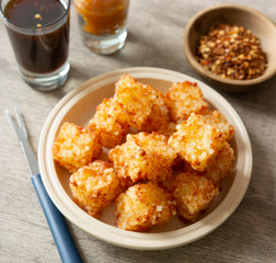Tapioca dice, typical northeast brazilian food with chilli sugar syrup over wooden table