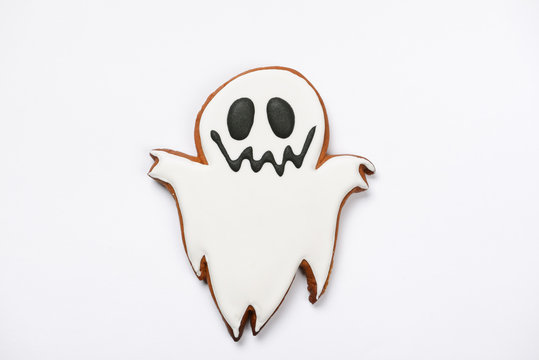 The hand-made eatable gingerbread Halloween ghost on white background