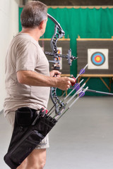 Archer Training With The Bow. Shooting the target in the background .