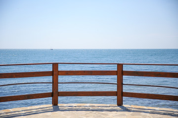 wooden railing on the pier. the view of the sea from the pier