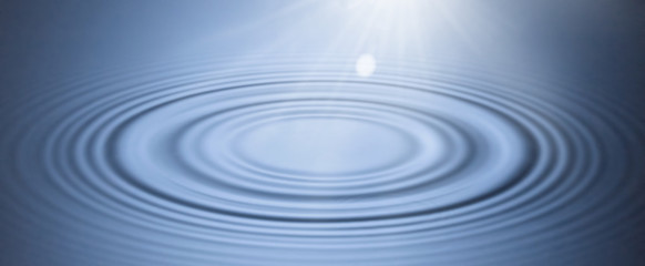 Blue background smooth circles on the water illuminated by soft light