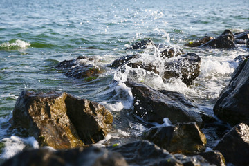 sea waves crashing on stones with splashes. background of sea waves