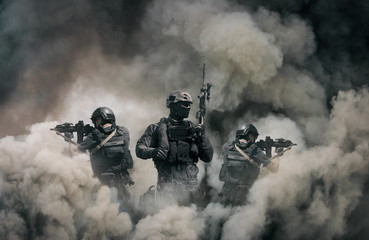 Swat forces between smoke and gas in battle field - obrazy, fototapety, plakaty