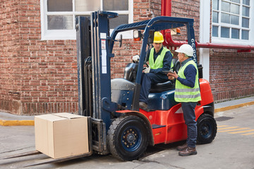 Workman with package on the forklift