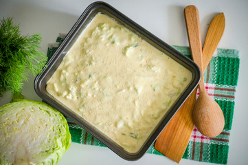 Pastry dough with cabbage on baking tray