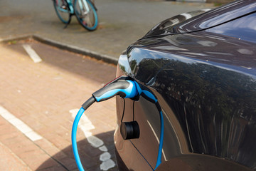 Electric car battery charging at a charge station, closeup view