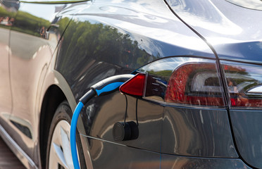 Electric car battery charging at a charge station, closeup view
