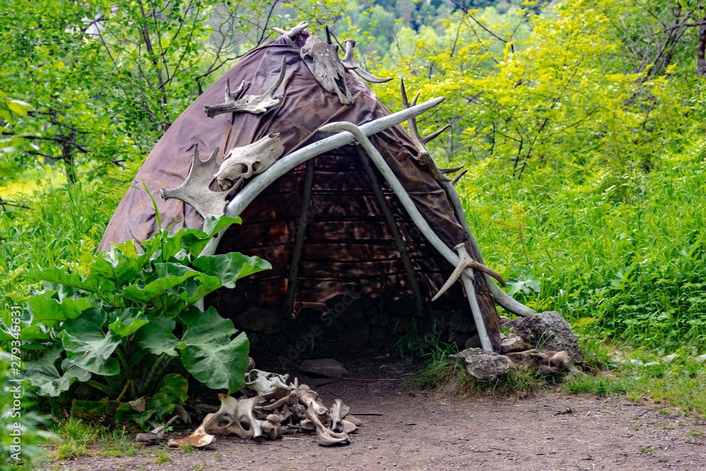 Wall mural Reconstruction of the human dwelling of the Stone Bronze Age. household items. archaeological excavations concept.