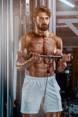 Fototapeta na wymiar Body Building in Progress. Muscular Men Exercise At the Gym