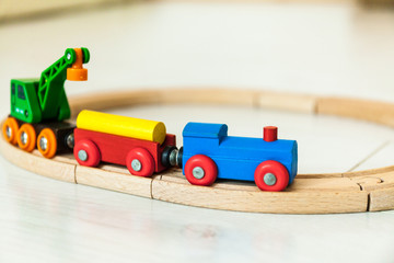 Child'd wooden train on the white floor