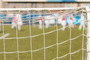 the grid from the football goal in focus the football field is blurred in the background