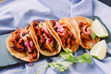 Tacos filled with cochinita pibil on a natural background. Authentic mexican tacos from Yucatan, Mexico