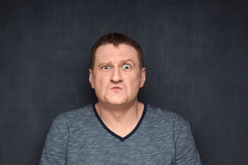 Obraz premium Portrait of frightened man with shocked expression