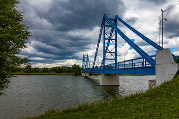 Picturesque blue footbridge across the river