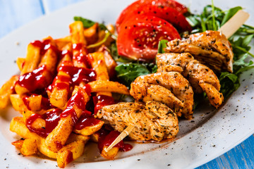 Fried chicken strips, french fries and vegetables