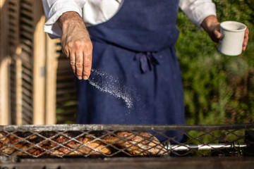 man cooking meat on grill