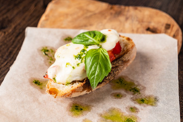 Traditional italian bruschetta with cherry tomatoes, cream cheese, basil leaves