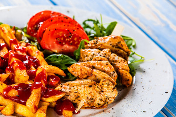 Fried chicken strips, french fries and vegetables