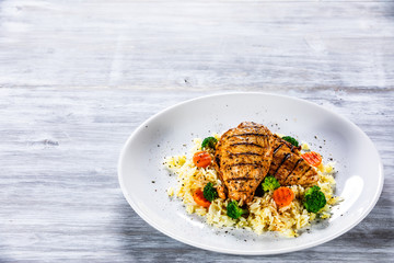 Grilled chicken fillets, rice and vegetables