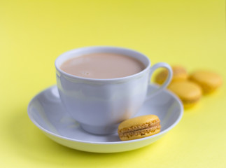 macaroons, delicious almond cookies and a Cup of coffee with cream on the table