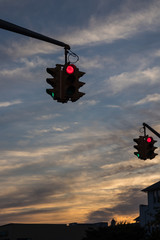 Traffic light with red light against the evening sky in USA.  Selective focus.