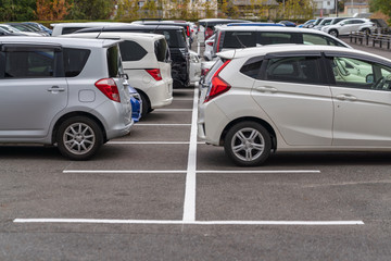 row of cars parked in outdoor parking