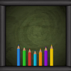 Chalkboard background with colorful pencils