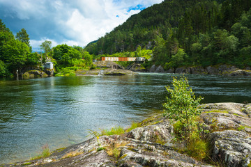 An indoor metal bridge over a river full of salmon, Norway