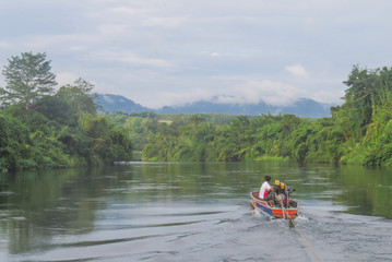 River Kwai. Motorboat driver pulls a raft cable