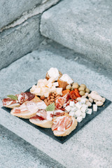 Bruschettes and a picnic with prosciutto. Italian theme in food, cheese and meat sliced.