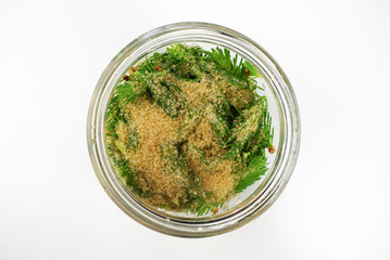 Spruce cones and raw sugar in bowl, making syrup