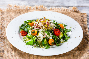 Salad with white rice on wooden background