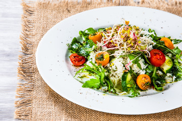 Salad with white rice on wooden background