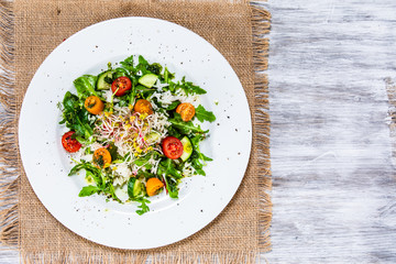 Salad with white rice on wooden background
