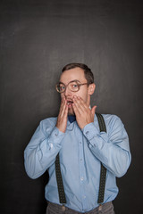 Surprised Funny teacher or business man on blackboard