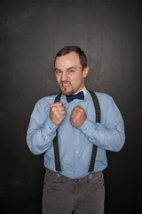 Funny Angry teacher or business man on blackboard
