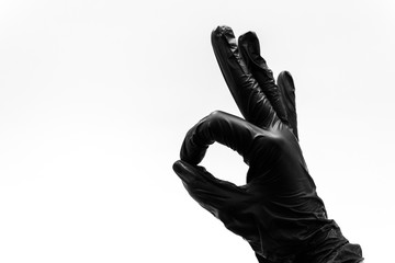 Female hand in black glove show gestures, signs and symbols isolated on white background. Two...