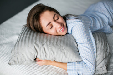 Beautiful young woman sleeping in her bedroom.