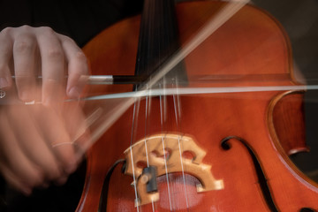 A young cellist practices intensely in this close up high resolution photo of strings, cello, and...