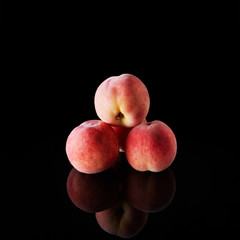 Fresh peaches on black background